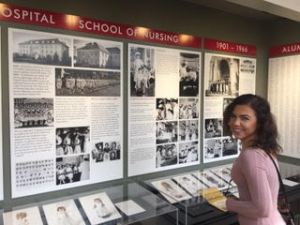 pharmacy student in front of a history display